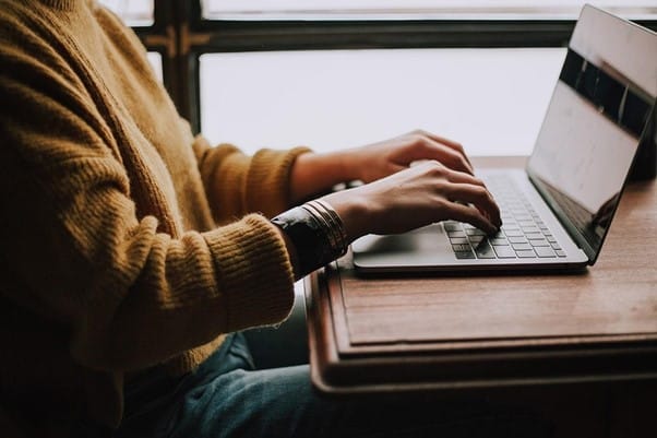 person sitting front of laptop